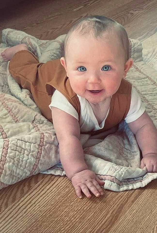 Khloe is registered to the contest to win money with this photo: baby, baby_toddler_clothing, cheek, comfort, eye, finger, flash_photography, floor, flooring, hand, happy, iris, mammal, nose, person, skin, sleeve, smile, textile, toddler