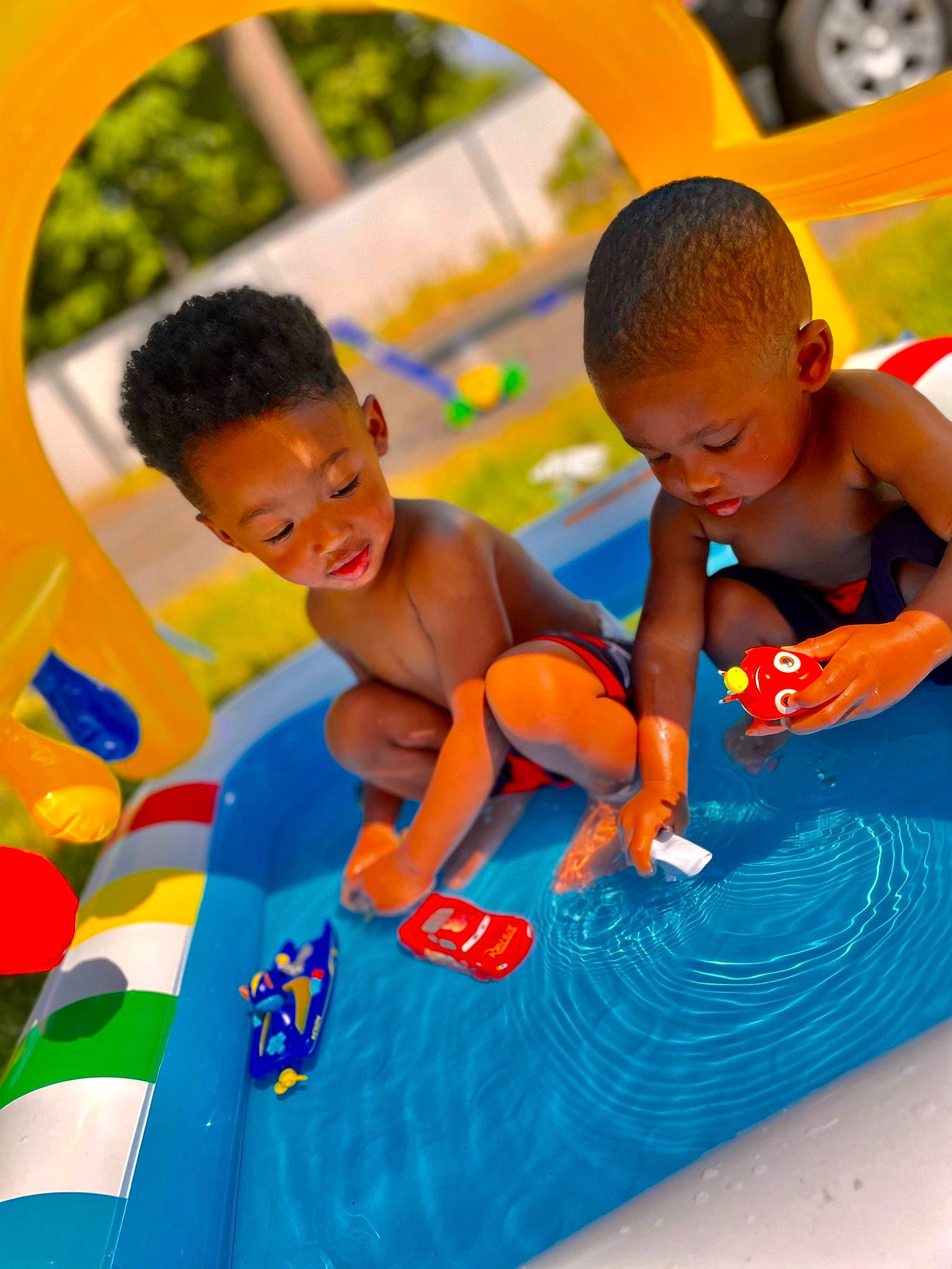 Landon is registered to the contest to win money with this photo: aqua, azure, baby, child, event, facial_expression, fun, grass, happy, human_settlement, leisure, person, play, playground, recreation, shorts, summer, t_shirt, toddler, water