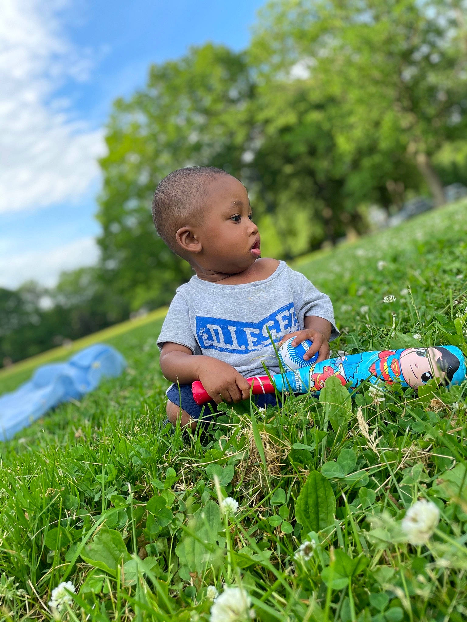 Mason joined the competition — help win amazing prizes! baby_toddler_clothing, electric_blue, flower, grass, grass_family, grassland, groundcover, happy, landscape, lawn, leisure, meadow, people_in_nature, person, plant, shorts, sky, t_shirt, terrestrial_plant, toddler