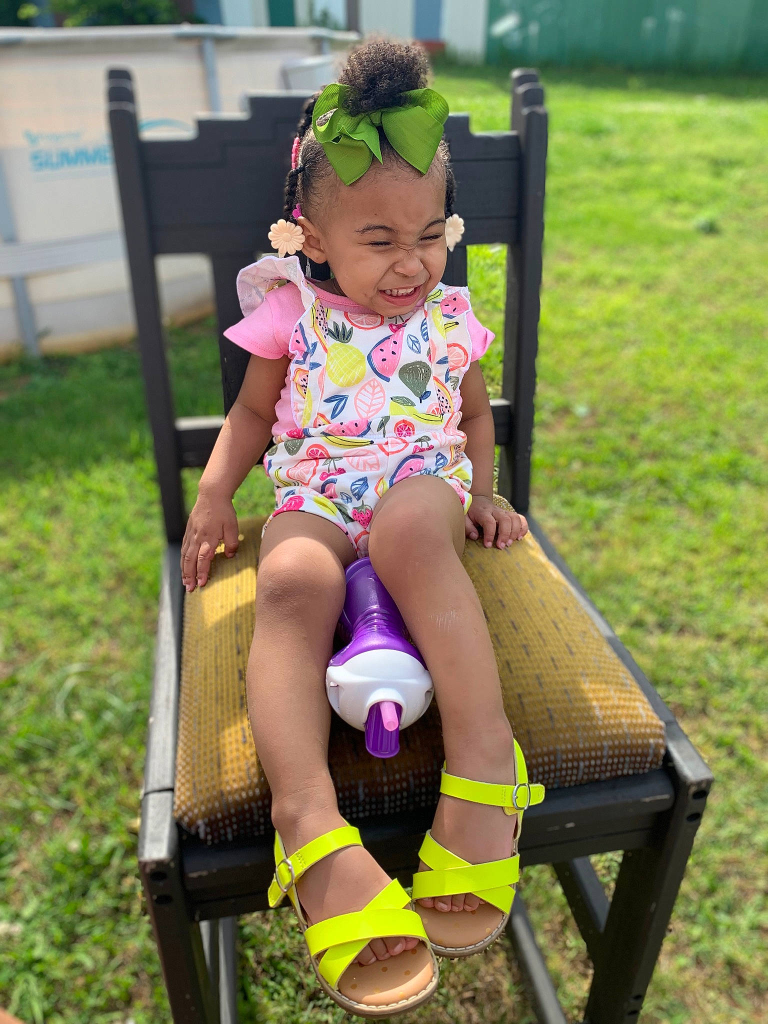 Honesty is registered to the contest to win money with this photo: baby_toddler_clothing, event, face, fun, grass, happy, head, headgear, human_leg, leg, leisure, person, personal_protective_equipment, purple, recreation, smile, sock, summer, thigh, toddler