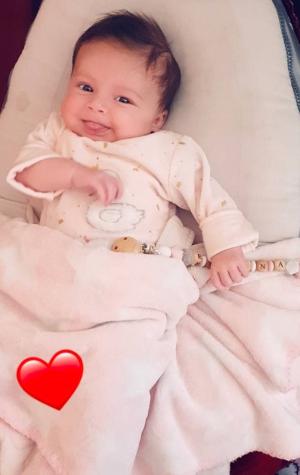 Elyana participe au concours pour gagner de l'argent avec cette photo : baby, baby_products, baby_toddler_clothing, carmine, cheek, child, comfort, heart, holiday, linens, lip, love, mouth, nose, organ, peach, person, pink, sitting, skin