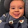 Matthias is registered to the contest to win money with this photo: baby, infant, child, smiling, happy, tongue_out, portrait, close_up, face, eyes, car_seat, seated, clothing, onesie, snowman_pattern, indoor, head, cute, photography, grinning