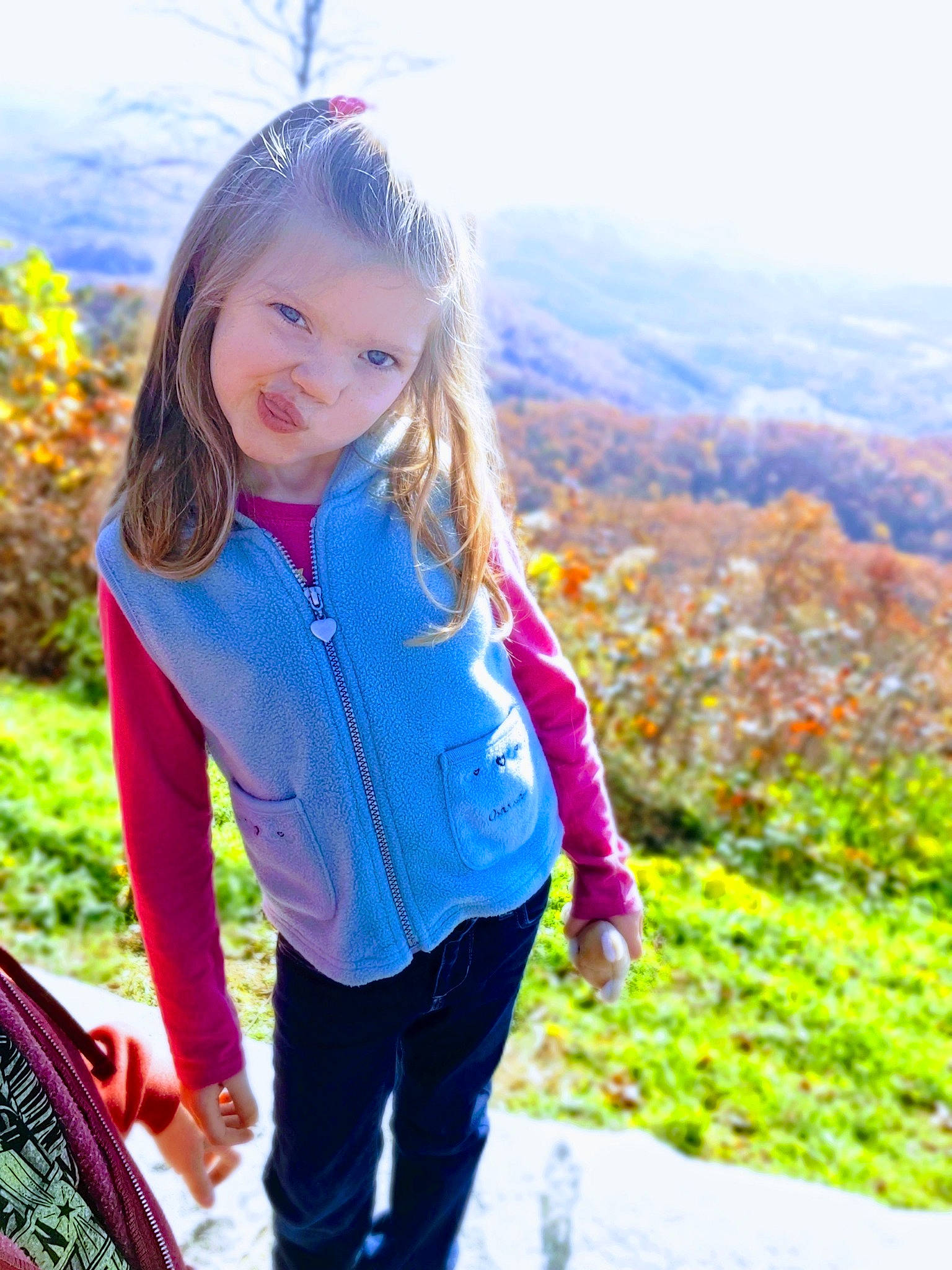 Lyla is registered to the contest to win money with this photo: clothing, electric_blue, fun, grass, grass_family, happy, iris, jacket, jeans, leisure, long_hair, morning, people_in_nature, person, plant, recreation, sky, smile, sunlight, toddler