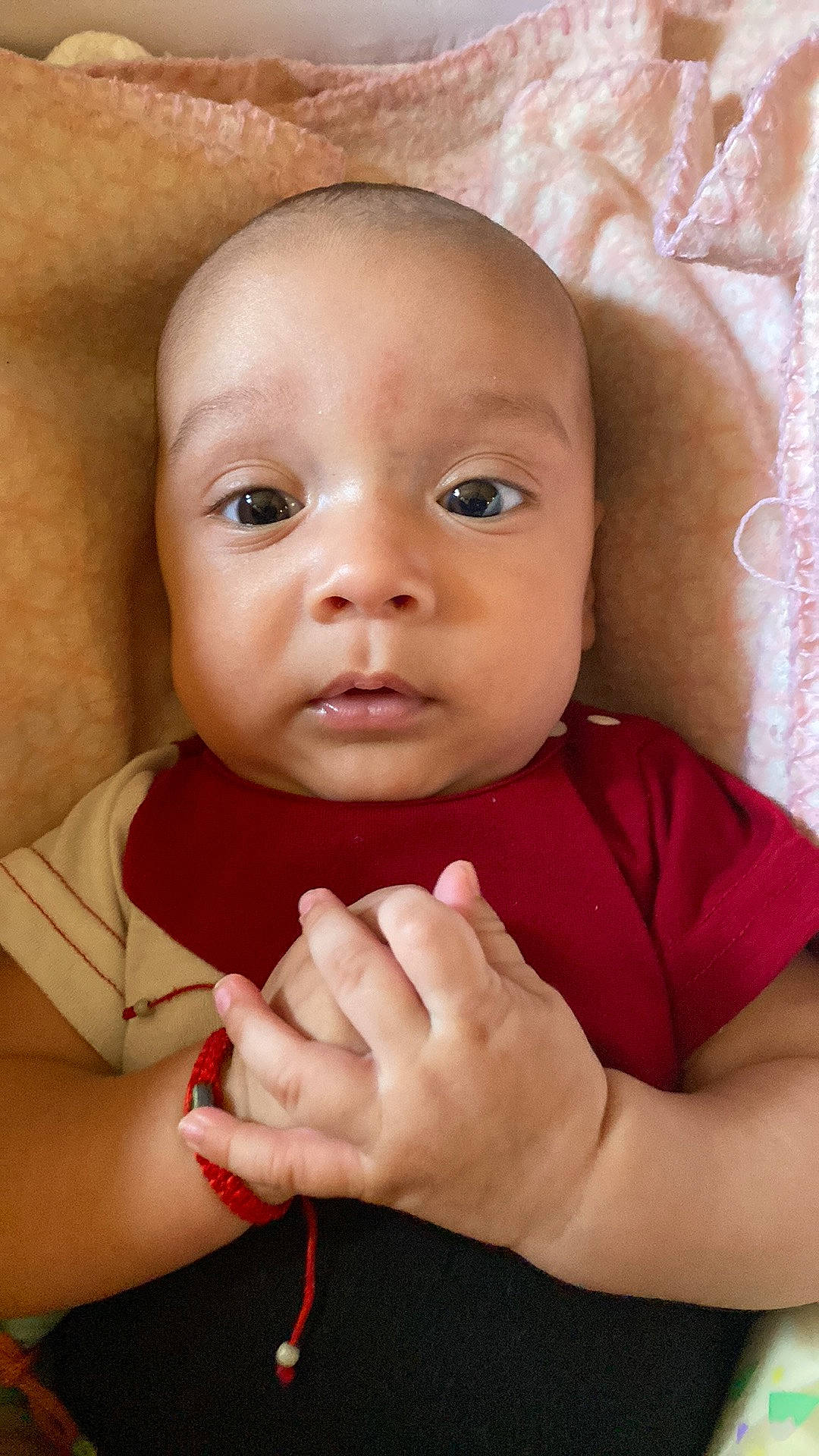 Jeremias is registered to the contest to win money with this photo: arm, baby, baby_toddler_clothing, cheek, chin, eyebrow, eyelash, finger, flash_photography, gesture, hand, happy, lip, nose, person, pink, skin, smile, textile, thumb