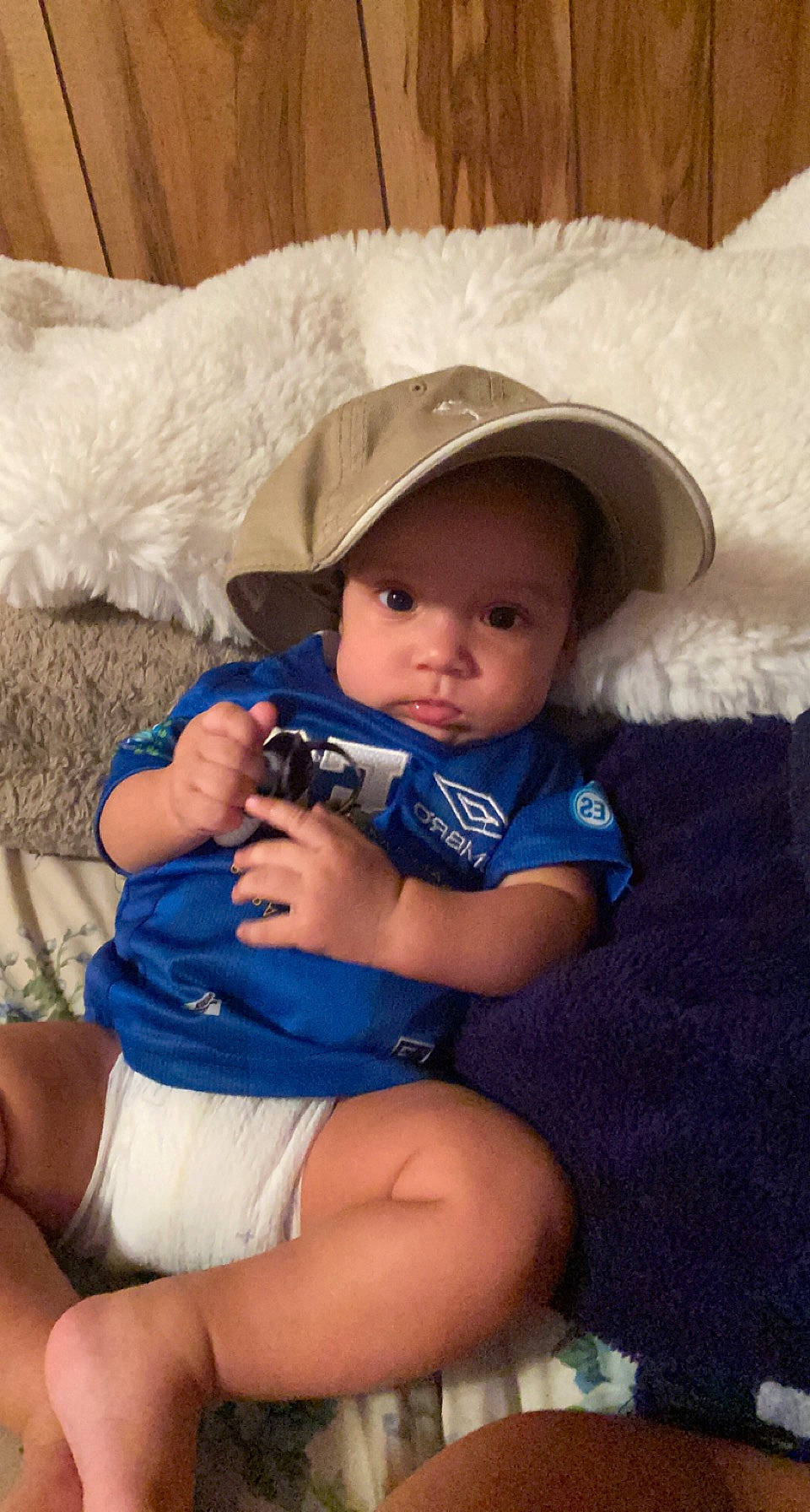 Jeremias joined the competition — help win amazing prizes! abdomen, baby, baby_toddler_clothing, child, comfort, couch, electric_blue, eye, face, hat, headwear, human_leg, iris, lap, nail, person, sitting, skin, sun_hat, thigh