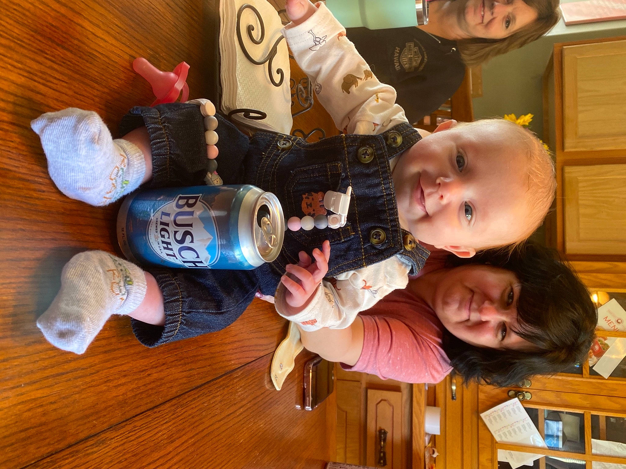 Emery is registered to the contest to win money with this photo: baby, bottle, cabinetry, child, drink, drinkware, flooring, food, fun, hardwood, head, joy, person, plastic_bottle, play, room, smile, toddler, tree, varnish