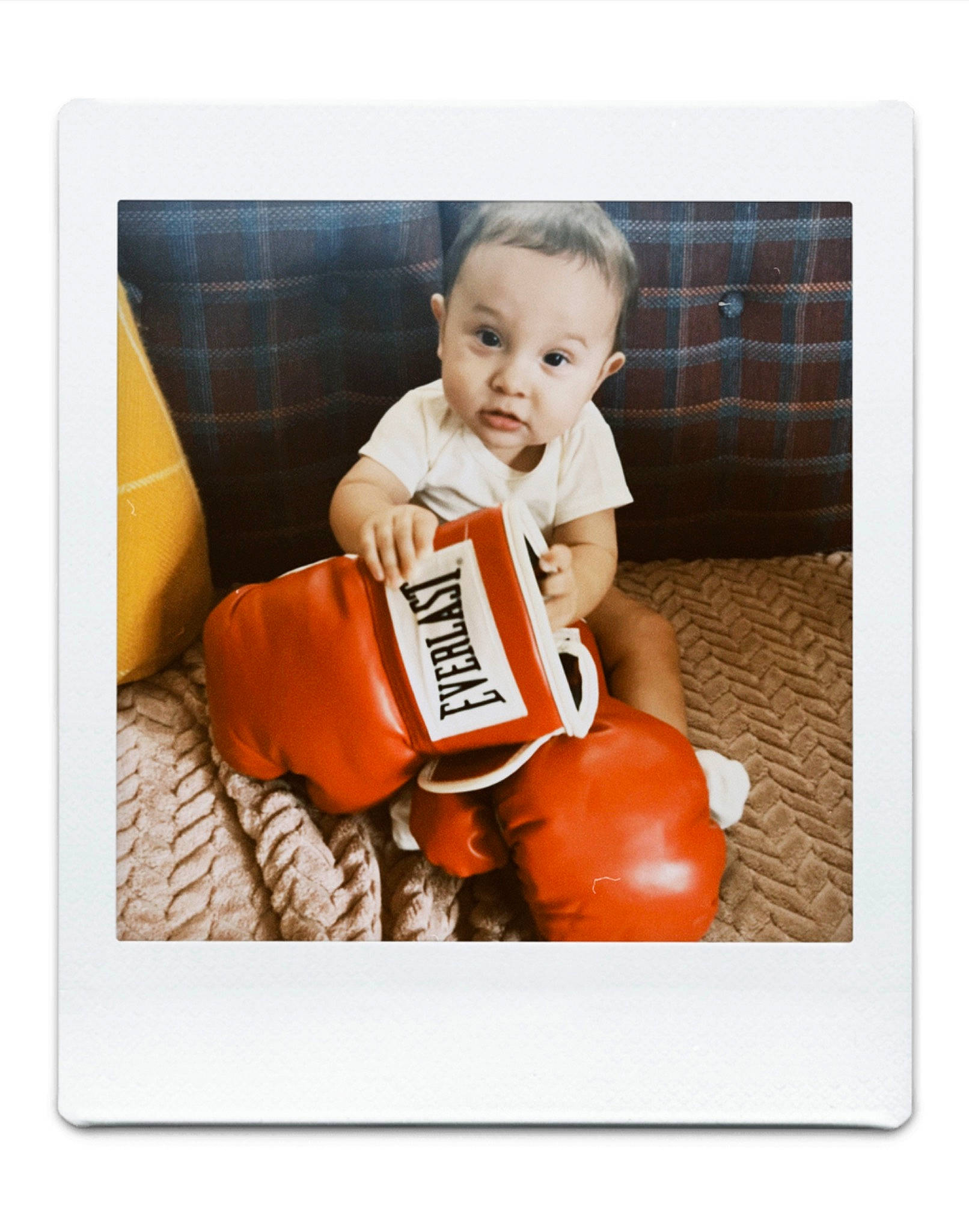 Ezekiel is registered to the contest to win money with this photo: baby, baby_products, baby_toddler_clothing, chair, comfort, font, fruit, happy, natural_foods, orange, person, plant, play, product, rectangle, sitting, smile, stock_photography, t_shirt, toddler
