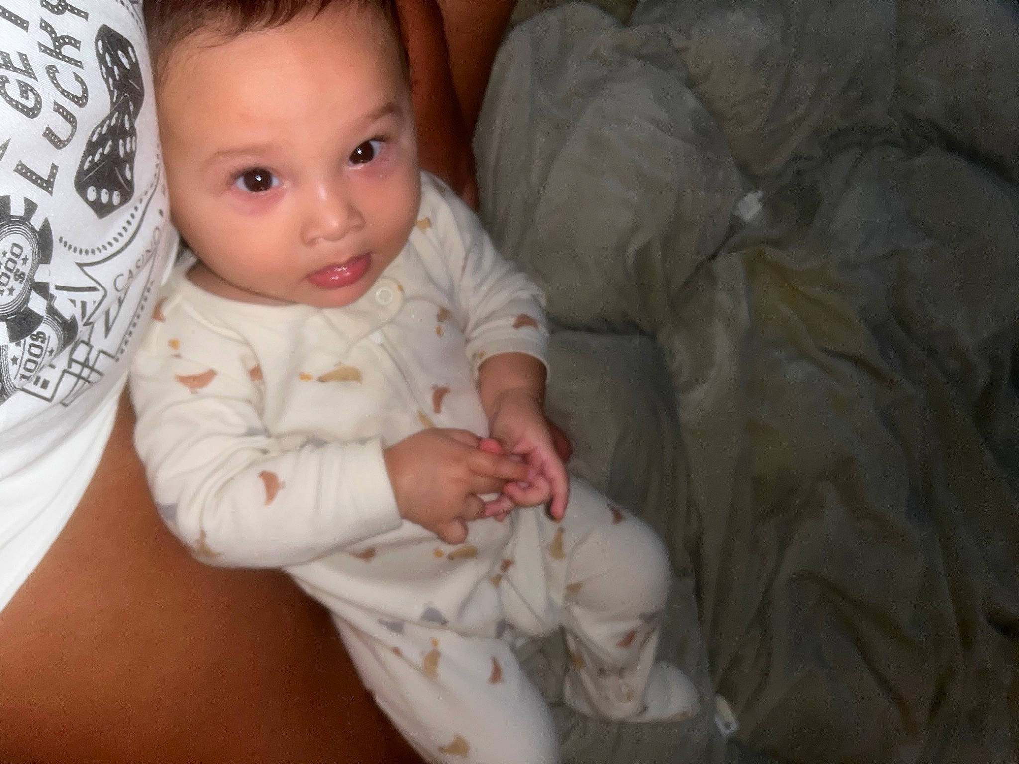 Ezekiel is registered to the contest to win money with this photo: baby, baby_toddler_clothing, cheek, child, comfort, eye, face, finger, flooring, gesture, happy, head, human_body, nose, person, sitting, skin, sleeve, smile, thumb