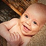 baby, smiling, face, happy, child, infant, skin, eyes, hands, portrait, closeup, cute, lying_down, blanket, cozy, soft_light, expression, human, young, warm