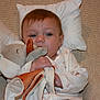 Brianna is registered to the contest to win money with this photo: baby, blue_eyes, child, comfort, couch, cute, elephant_toy, face, hair, hand, holding, indoor, infant, onesie, pillow, plush_toy, relaxed, resting, sleepy, soft_furniture
