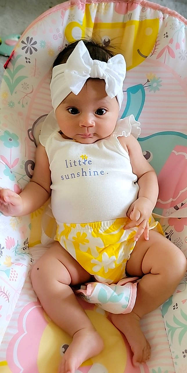 Amirah is registered to the contest to win money with this photo: arm, baby, baby_toddler_clothing, cheek, chest, child, eyelash, finger, happy, headwear, leg, person, pink, skin, sleeve, stomach, textile, thigh, thumb, toddler