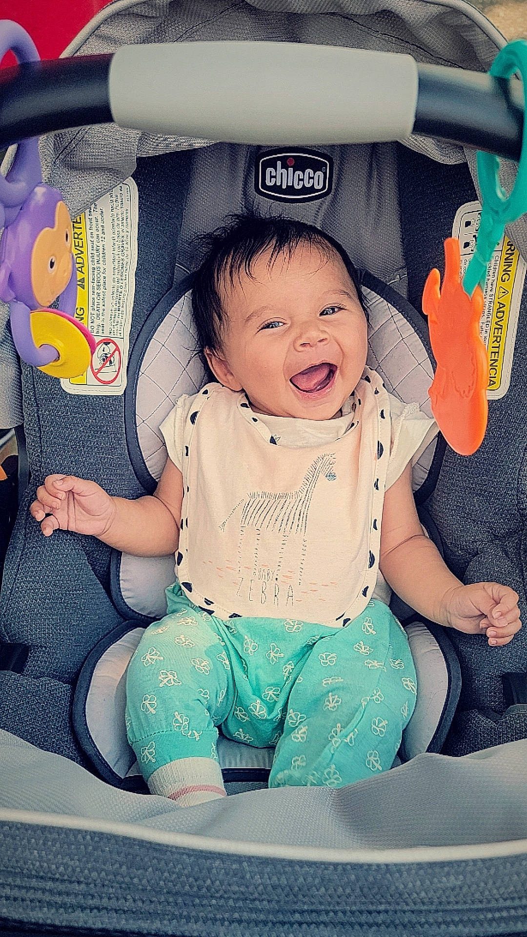 Amirah joined the competition — help win amazing prizes! baby, baby_carriage, baby_in_car_seat, baby_products, baby_toddler_clothing, car_seat, child, comfort, finger, fun, gesture, happy, lap, pattern, person, pink, product, sitting, smile, toddler