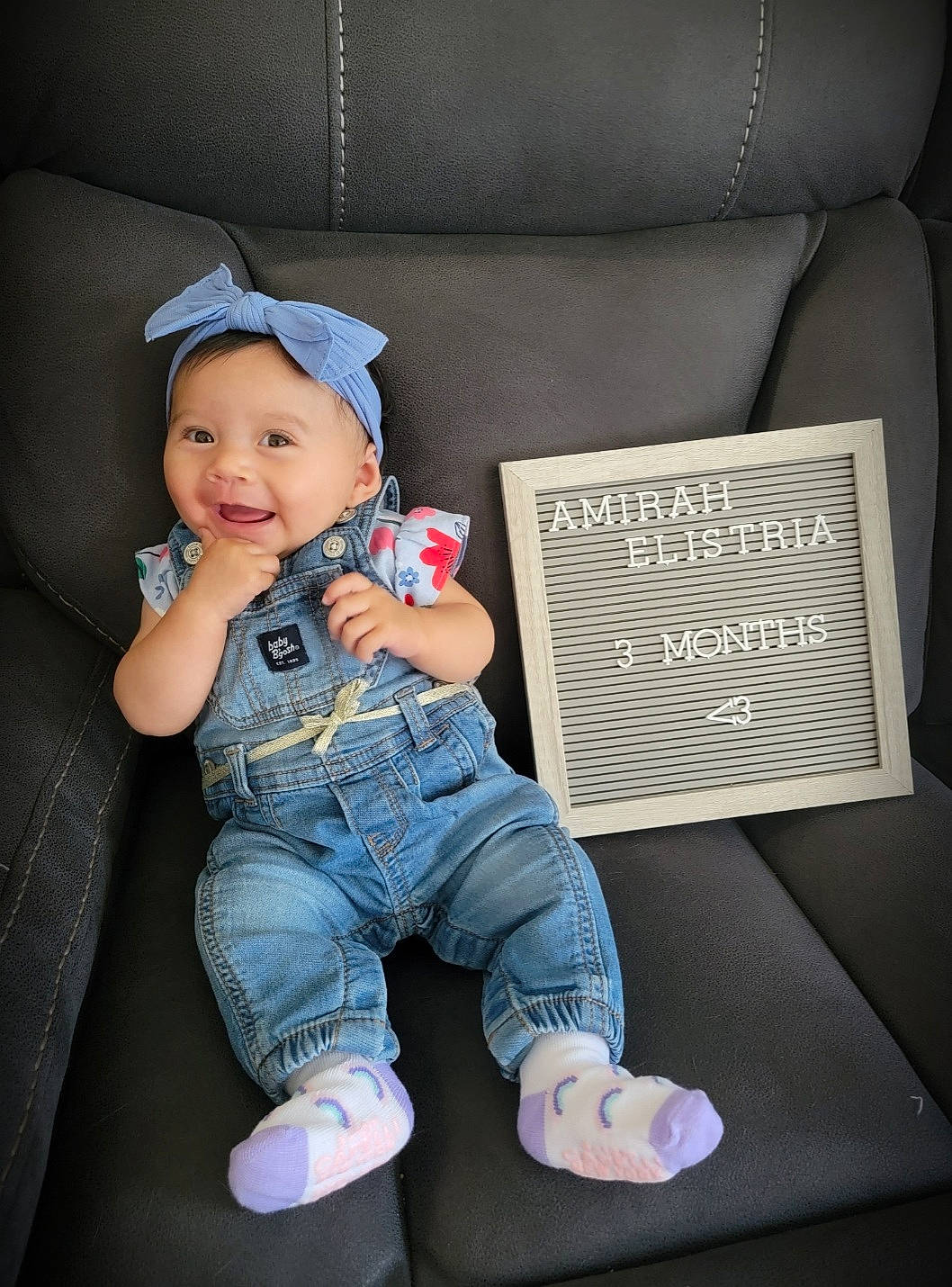 Amirah is registered to the contest to win money with this photo: baby, baby_toddler_clothing, cap, cheek, child, clothing, comfort, denim, electric_blue, eye, flash_photography, foot, head, headwear, jeans, joy, leg, person, sitting, sleeve