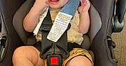 Matt is registered to the contest to win money with this photo: baby, buckle, candid, car_seat, chubby_cheeks, closeup, clothing, hand, happy, headrest, high_angle, indoor, infant, legs, portrait, safety_tags, seatbelt, smiling, socks, toy