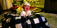 Matt joined the competition — help win amazing prizes! baby, blanket, bokeh, carpet, child, christmas_tree, curtains, decorations, happy, hat, holiday_lights, indoors, infant, living_room, onesie, plaid, portrait, smile, sofa, toy_train