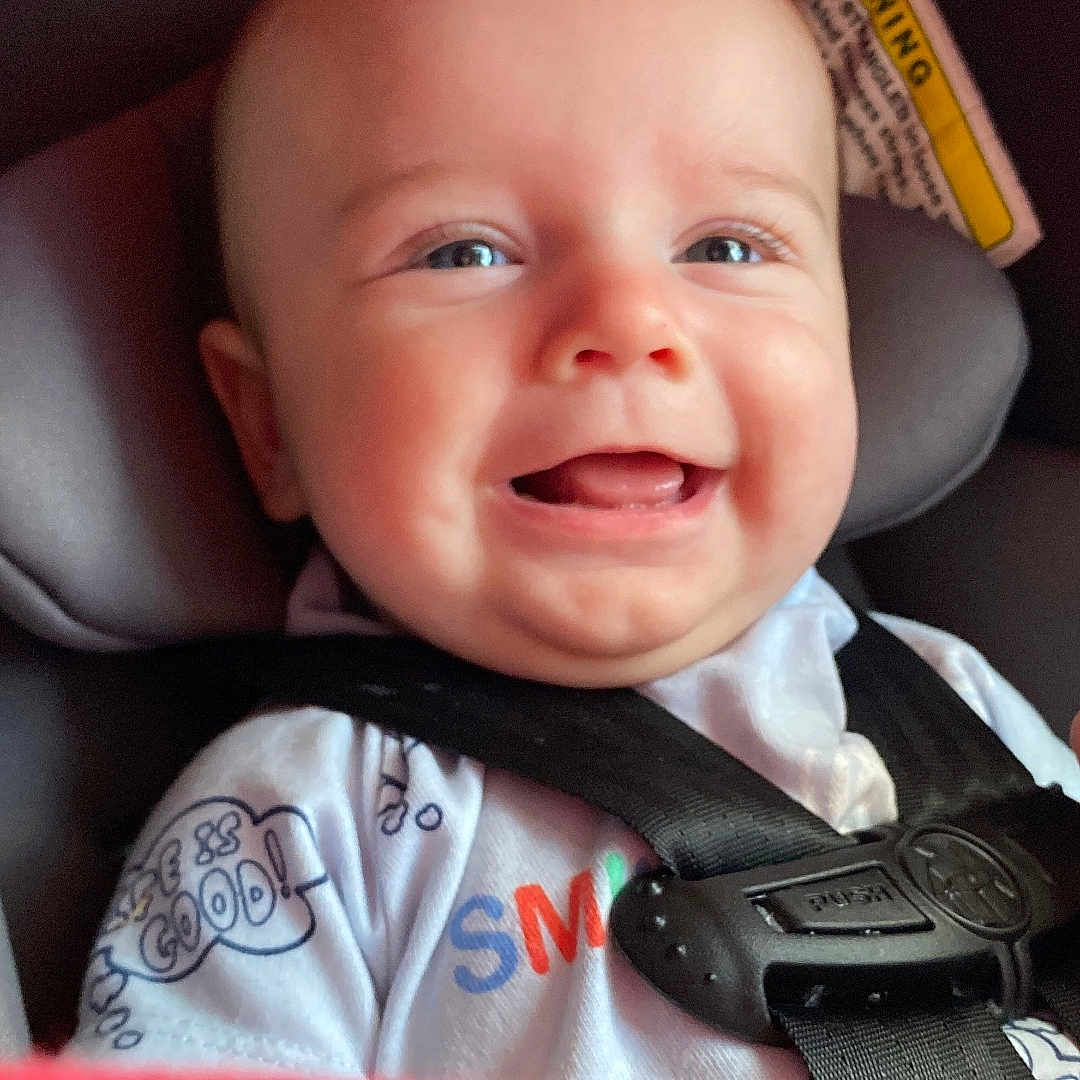 Matt joined the competition — help win amazing prizes! baby, car_interior, car_seat, cheeks, chubby, closeup, clothing, cute, eyes, hand, happy, harness, infant, onesie, passenger, portrait, safety_label, seat_belt, smiling, teeth