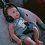 Lilith participe au concours pour gagner de l'argent avec cette photo : baby, headphones, game_controller, cushion, infant, child, cute, indoor, relaxing, plush, clothing, person, technology, gaming, smiling, comfort, seat, toy, expression, casual