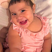 Hinata joined the competition — help win amazing prizes! baby, child, infant, smiling, happy, portrait, close_up, pink_outfit, bunny_ears, headband, bed, bedding, indoor, face, eyes, teething, sitting, cozy, adorable, photograph