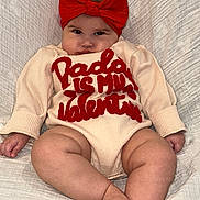 Stori is registered to the contest to win money with this photo: adorable, baby, blanket, child, clothing, comfortable, cute, expression, face, feet, hands, headband, indoors, infant, legs, portrait, red_bow, sitting, soft_texture, young