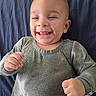 Ezekiel joined the competition — help win amazing prizes! baby, child, infant, smiling, happy, portrait, face, eyes, teeth, bald, sitting, lying_down, green_clothing, long_sleeves, blanket, fabric, indoor, close_up, joyful, photography