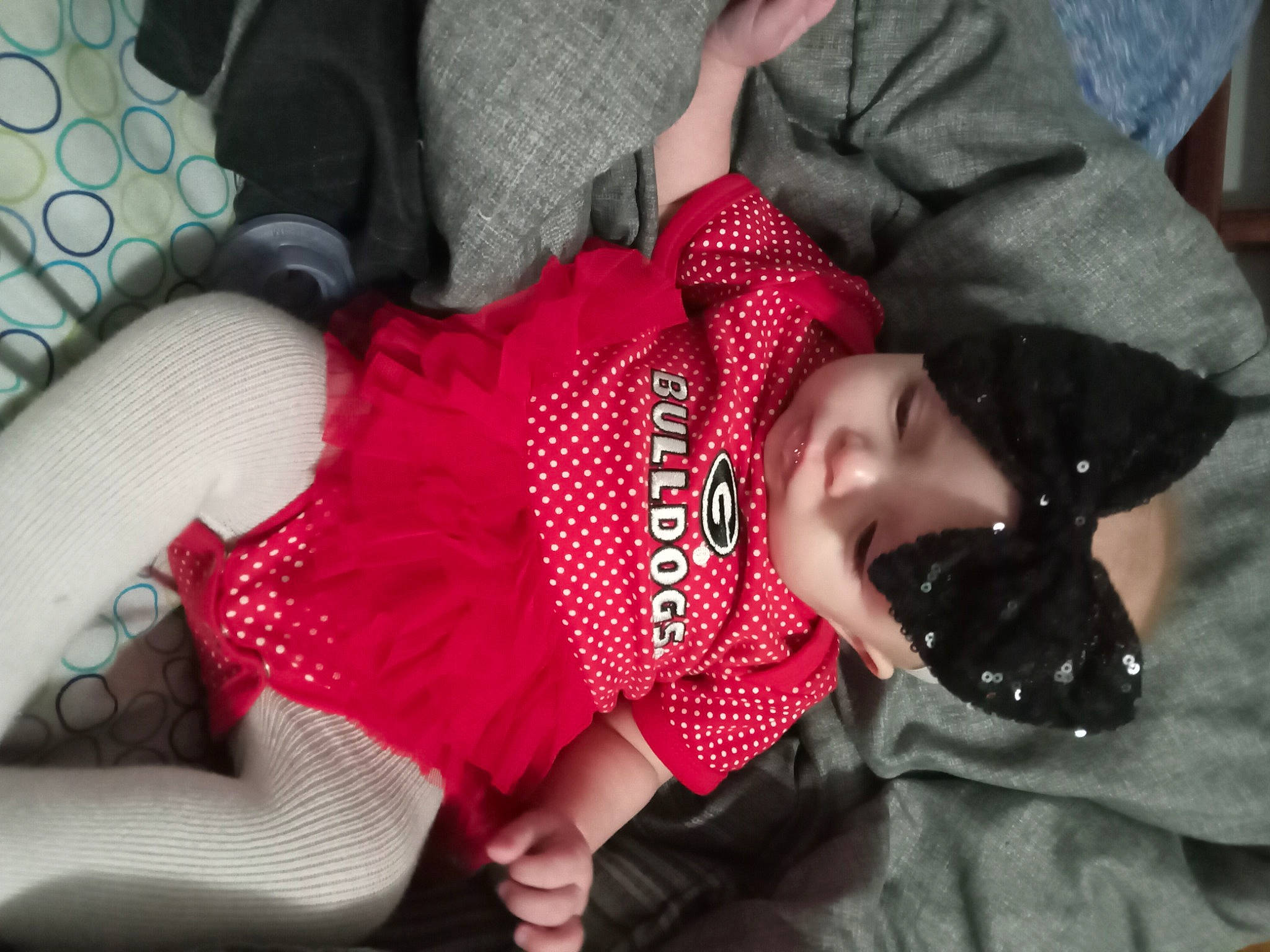 Mckinleigh is registered to the contest to win money with this photo: arm, baby, baby_toddler_clothing, carmine, child, comfort, fashion_accessory, human_body, human_leg, joint, knee, leg, magenta, pattern, person, plaid, sitting, sleeve, sock, thigh