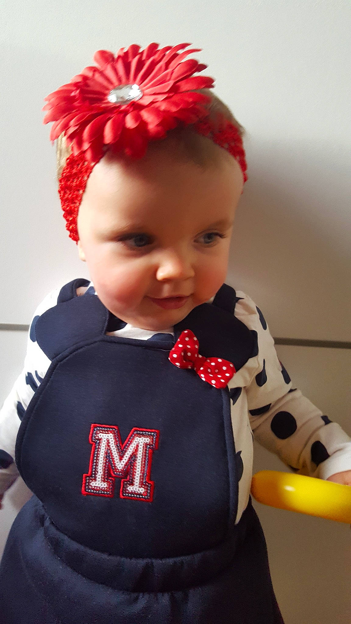 Marie Lou participe au concours pour gagner de l'argent avec cette photo : child, doll, hair_accessory, headgear, person, product, red, textile, toddler