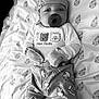 Dameon joined the competition — help win amazing prizes! baby, infant, pacifier, mittens, hat, pajamas, animal_print, blanket, pattern, face, sleepwear, cute, child, portrait, lying_down, monochrome, soft_texture, newborn, cozy, comfortable