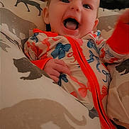 Ember joined the competition — help win amazing prizes! baby, child, infant, smiling, laughing, onesie, colorful_clothing, blanket, animal_print, cozy, indoors, happy, cute, face, portrait, young_child, hand, fabric, comfort, warm