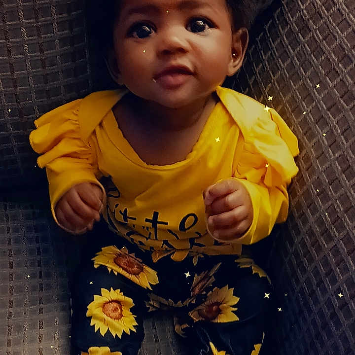 Nova is registered to the contest to win money with this photo: baby, bodypart, clothing, couch, face, finger, footwear, furniture, hand, happy, head, hosiery, pants, person, photography, portrait, shoe, sitting, smile, sock