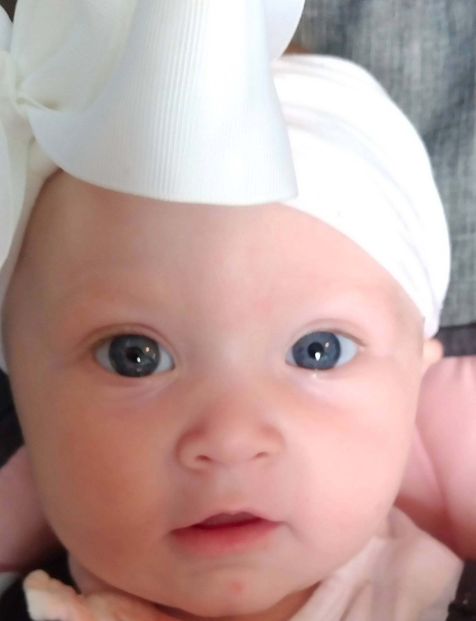 Khloe is registered to the contest to win money with this photo: baby, baby_toddler_clothing, cap, cheek, chin, costume_hat, eye, eyebrow, eyelash, face, gesture, head, headgear, headwear, human_body, lip, nose, person, pink, skin