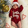 baby, infant, christmas, holiday, santa_hat, red_sweater, candy_cane, heart_shape, golden_ornament, pine_tree, blanket, festive, cute, holiday_decor, christmas_tree, smiling, indoors, soft_texture, cozy, seasonal