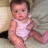 baby, child, comfortable, couch, cute, face, foot, hand, home, indoors, infant, pillows, pink_clothing, plush, portrait, sitting, skin, soft_lighting, wide_eyes, young_child