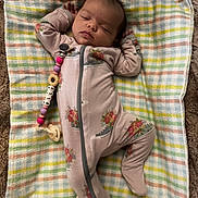 Elliana joined the competition — help win amazing prizes! baby, infant, sleeping, blanket, onesie, pacifier, pacifier_clip, beads, floral_pattern, striped_blanket, cozy, nap, cute, portrait, indoor, soft_texture, hand, footie_pajamas, peaceful, resting