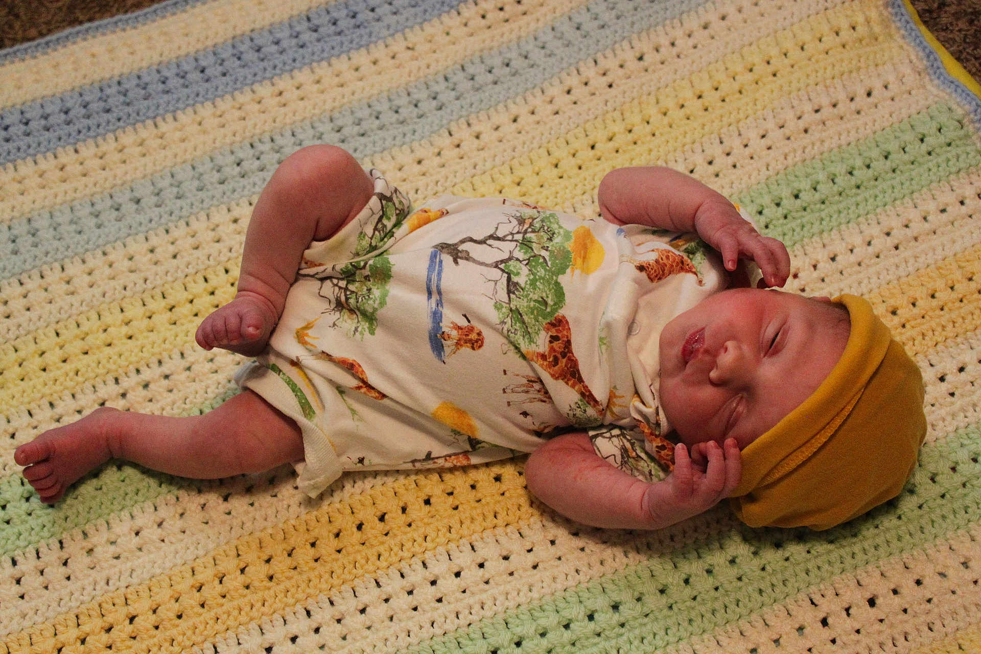 Theodore is registered to the contest to win money with this photo: newborn, baby, sleeping, onesie, hat, blanket, crochet, animal_print, giraffe, pastel_colors, infant, cute, peaceful, indoor, lying_down, small_hands, small_feet, soft_texture, cozy, toddler