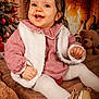 baby, child, smile, red_checkered_clothing, white_vest, tights, golden_shoes, blanket, christmas_tree, ornaments, fireplace, fire, teddy_bear, holiday, indoors, festive, warm_lighting, cute, portrait, happy