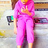 Zeezee is registered to the contest to win money with this photo: brick_wall, casual, child, colorful, concrete, curious, door, expression, girl, hair_beads, outdoor, pink_outfit, porch, shoes, sitting, snack_box, socks, tablets, technology, young