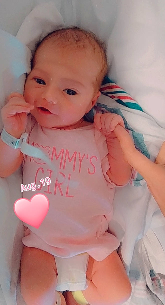 Emberlee is registered to the contest to win money with this photo: baby, baby_products, baby_toddler_clothing, cheek, child, finger, lip, nose, person, pink, product, skin, smile, toddler