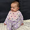Luna is registered to the contest to win money with this photo: baby, infant, pajamas, bib, purple, flower_pattern, butterfly_pattern, blanket, couch, portrait_mode, photo_gallery, smiling, sitting, curious, indoors, child, young_baby, cute, screen_capture, mobile_interface