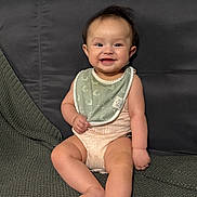 Luna is registered to the contest to win money with this photo: baby, child, smiling, sitting, couch, blanket, bib, clothing, happy, indoor, person, infant, cute, face, feet, head, skin, young, portrait, cozy