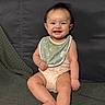 baby, child, smiling, sitting, couch, blanket, bib, clothing, happy, indoor, person, infant, cute, face, feet, head, skin, young, portrait, cozy