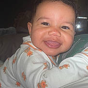 Saylor joined the competition — help win amazing prizes! baby, smiling, tongue_out, onesie, teddy_bear_print, infant, cute, face, happy, child, indoor, portrait, person, sleepwear, closeup, skin, eyebrows, earrings, soft_lighting, mirror