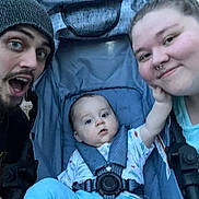 Jackson is registered to the contest to win money with this photo: baby, stroller, man, woman, outdoor, family, smile, happy, child, beanie, clothing, nature, trees, portrait, expression, face, parent, childcare, casual, daylight