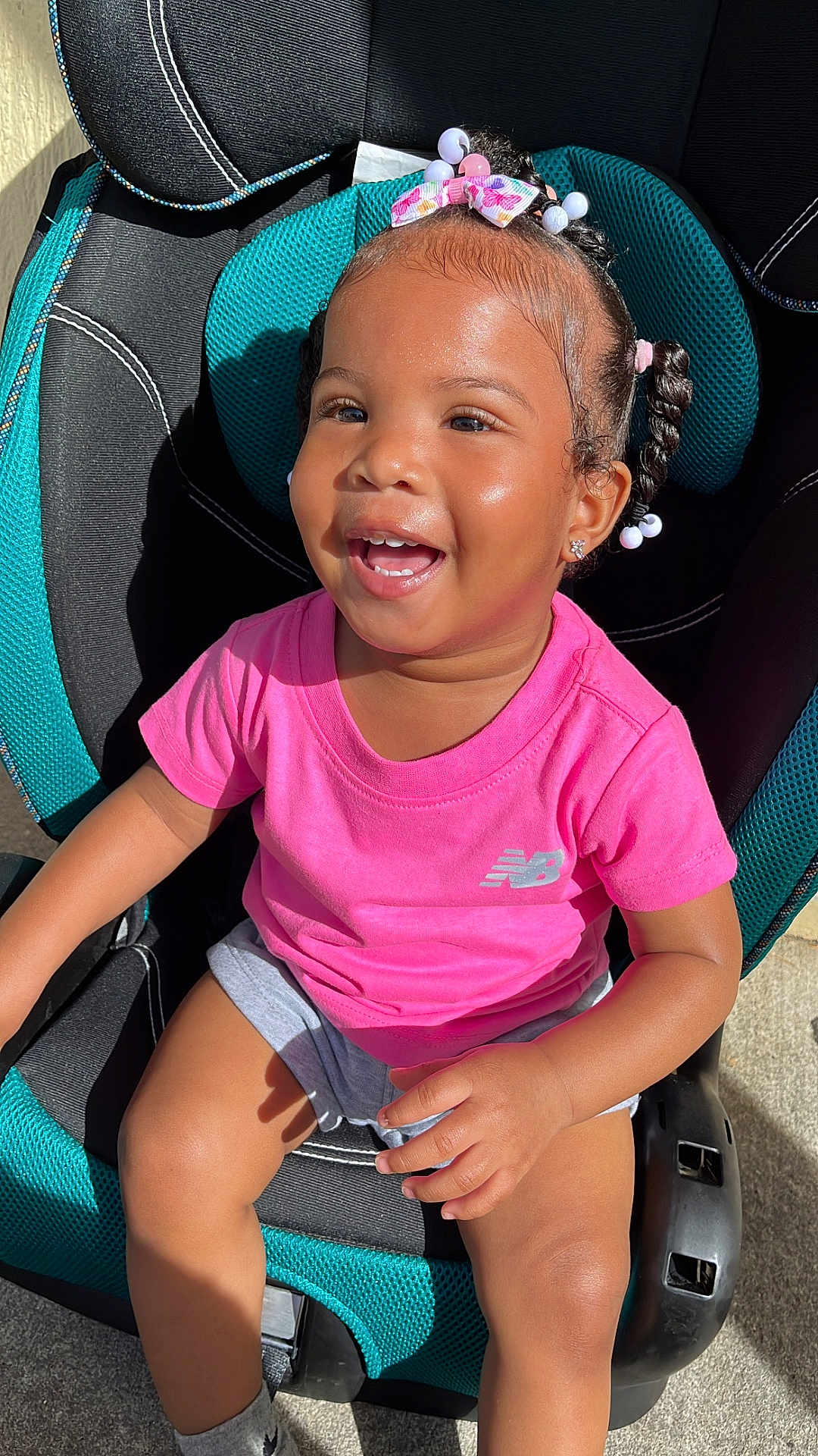 Stormi Lynn Punter joined the competition — help win amazing prizes! toddler, child, smiling, car_seat, braided_hair, beads, pink_shirt, shorts, sunlight, happy, outdoor, seat, person, cute, portrait, young_child, fashion, casual, joy, daylight