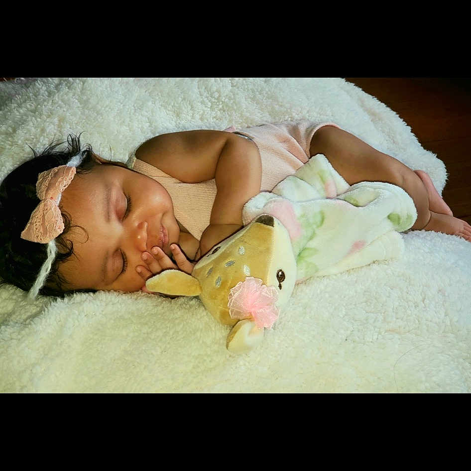 Blakely is registered to the contest to win money with this photo: abdomen, baby, bed, bedding, bedroom, bedtime, child, comfort, dress, event, flash_photography, flesh, happy, human_leg, knee, linens, nap, sitting, thigh, toddler