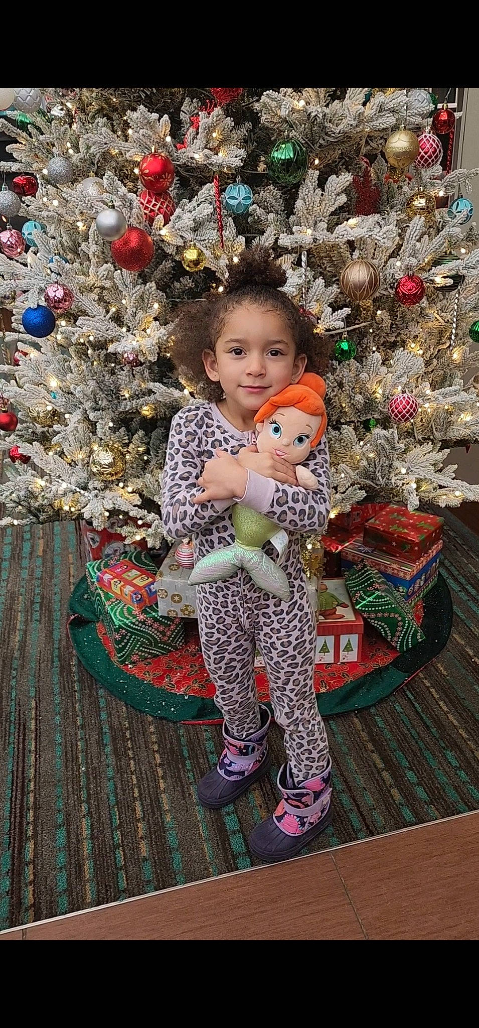 Arlia is registered to the contest to win money with this photo: baby_toddler_clothing, child, christmas, christmas_decoration, christmas_eve, christmas_ornament, christmas_tree, conifer, event, fun, happy, holiday, holiday_ornament, joy, ornament, person, smile, standing, toddler, toy