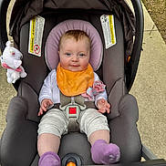 Scarlett joined the competition — help win amazing prizes! baby, bib, buckle, car_seat, child, clothing, happy, harness, headrest, infant, outdoor, pacifier, pacifier_clip, plush_toy, portrait, purple_socks, seat_padding, sidewalk, smile, stroller
