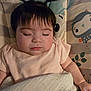 adorable, animal_print, baby, blanket, child, cushion, cute, face, hair, indoors, infant, pale_pink_shirt, peaceful, pigtails, portrait, resting, sleeping, soft, toddler, young_child