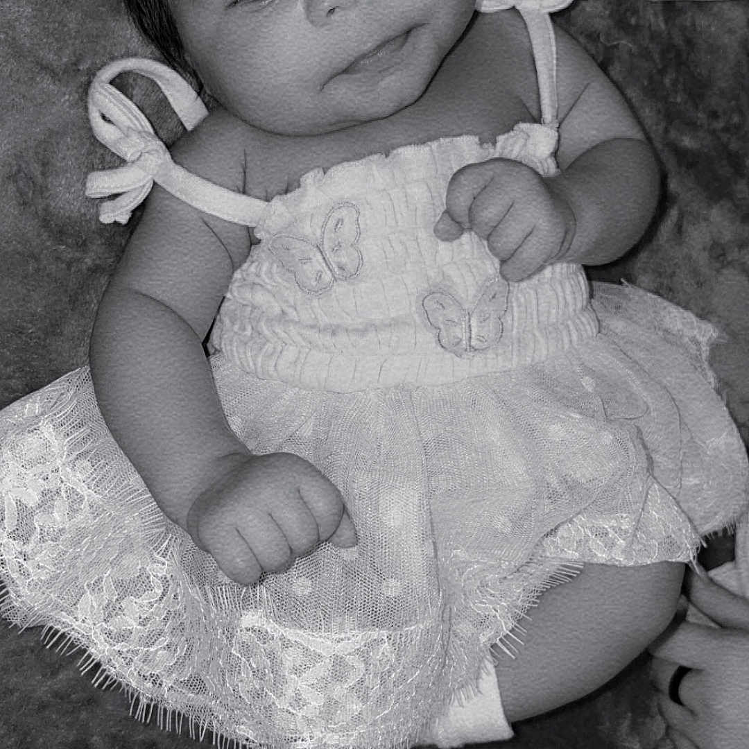 Mckenna Brook is registered to the contest to win money with this photo: baby, black_and_white, butterfly, child, clothing, cute, dress, face, foot, hand, infant, lace, lying_down, newborn, person, portrait, smile, sock, soft_texture, young