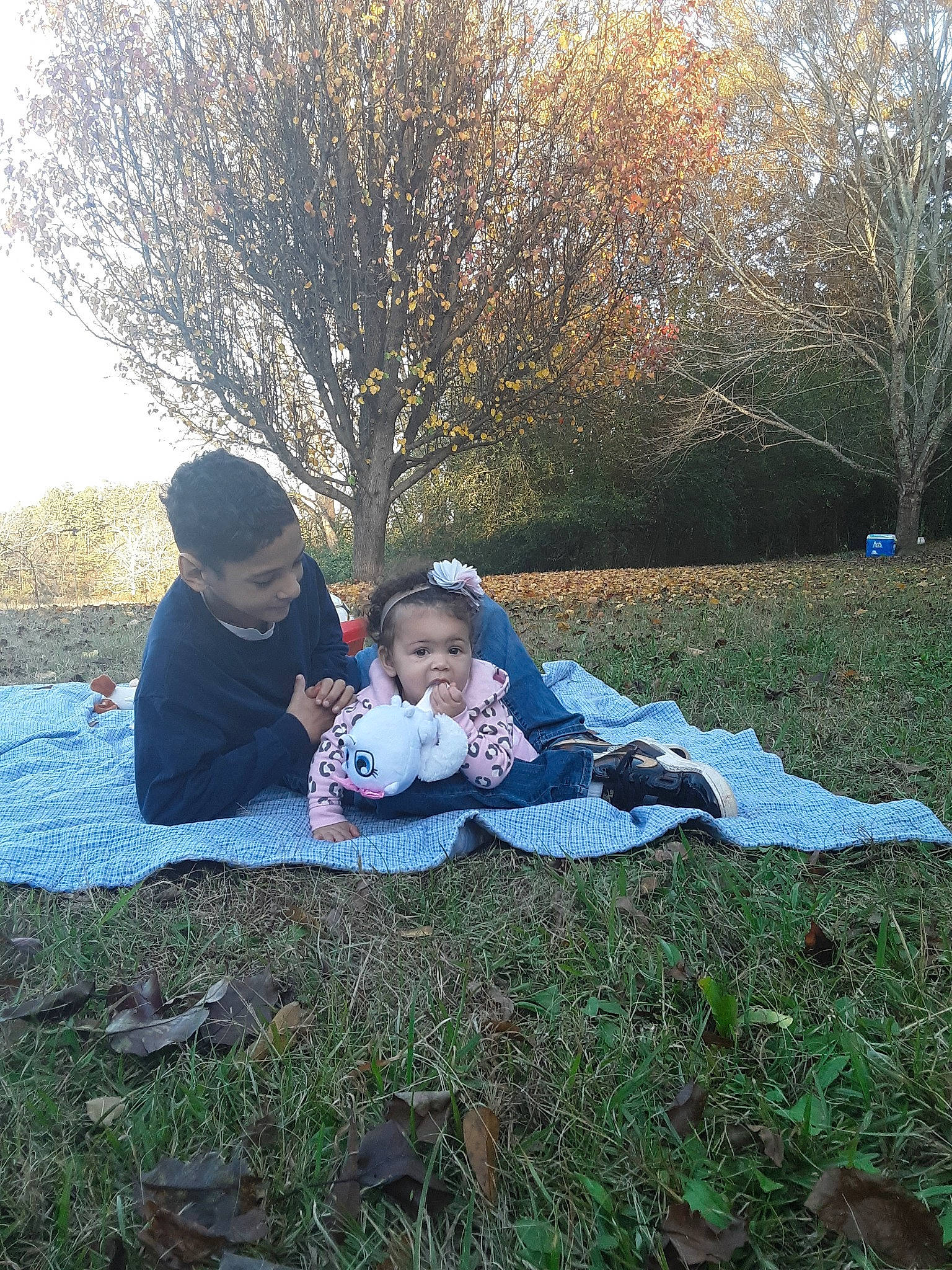 Marley is registered to the contest to win money with this photo: child, family, grass, leaf, leisure, people_in_nature, person, photograph, photography, plant, recreation, sitting, tree