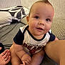 Braiden joined the competition — help win amazing prizes! baby, infant, child, cute, sitting, bed, bedding, pillow, hand, clothing, toddler, indoor, face, smile, skin, person, curly_hair, foot, leg, room